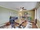 This dining room features wood floors, a ceiling fan, a table with chairs, and unique décor at 120 Crosby Dr, Indianapolis, IN 46227