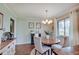 This dining area features a wood table, neutral décor, and natural light from the window at 120 Crosby Dr, Indianapolis, IN 46227