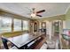 Bright dining room featuring wood floors, a ceiling fan and large windows overlooking the yard at 120 Crosby Dr, Indianapolis, IN 46227