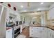 Bright kitchen with white cabinets, butcher block counters, and stainless steel appliances at 120 Crosby Dr, Indianapolis, IN 46227