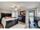 Comfortable main bedroom with a ceiling fan, large bed, and access to the outdoors at 120 Crosby Dr, Indianapolis, IN 46227