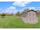 Backyard with a well-maintained storage shed and lush greenery at 120 Crosby Dr, Indianapolis, IN 46227