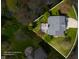 Aerial view of property featuring a backyard deck, mature trees, and driveway access at 12011 Glen Cove Dr, Indianapolis, IN 46236