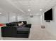 Finished basement featuring a modern sectional couch, neutral carpet, and a suspended tile ceiling at 12011 Glen Cove Dr, Indianapolis, IN 46236
