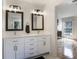 Bright bathroom with double vanity, framed mirrors, and modern fixtures at 12011 Glen Cove Dr, Indianapolis, IN 46236