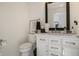 Stylish powder room with modern fixtures, decor, and framed mirror at 12011 Glen Cove Dr, Indianapolis, IN 46236