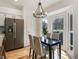 Sunlit dining area with stainless steel refrigerator and bay windows showcasing the outside at 12011 Glen Cove Dr, Indianapolis, IN 46236