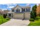 Charming two-story home featuring a two-car garage and manicured front lawn at 12011 Glen Cove Dr, Indianapolis, IN 46236