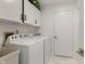 Bright laundry room with washer, dryer, and storage cabinets at 12011 Glen Cove Dr, Indianapolis, IN 46236