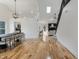 Open-concept living space with hardwood floors, fireplace, and staircase at 12011 Glen Cove Dr, Indianapolis, IN 46236