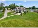 An aerial shot of the house and its expansive lawn, featuring mature trees at 1230 Amberley Way, Westfield, IN 46074