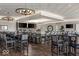 Upscale bar area with modern lighting, dark wood floors, multiple TVs, and a large selection of drinks at 1230 Amberley Way, Westfield, IN 46074