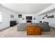 Finished basement featuring a gray couch, TV, and wood chest at 1230 Amberley Way, Westfield, IN 46074