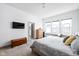 Bright bedroom featuring a TV, wood chest, three windows, and gray tones at 1230 Amberley Way, Westfield, IN 46074