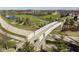 Scenic view of a bridge surrounded by lush greenery, a golf course, and a tranquil lake at 1230 Amberley Way, Westfield, IN 46074