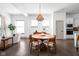 Bright dining room featuring a wooden table, large windows, and modern light fixture at 1230 Amberley Way, Westfield, IN 46074