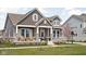 Charming two-story home with stone accents, inviting front porch, and manicured lawn at 1230 Amberley Way, Westfield, IN 46074