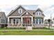 Charming two-story home with stone accents, inviting front porch, and manicured lawn at 1230 Amberley Way, Westfield, IN 46074