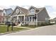 Charming two-story home with stone accents, inviting front porch, and manicured lawn at 1230 Amberley Way, Westfield, IN 46074