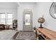 Bright foyer with decorative console table and stylish rug leading into the home at 1230 Amberley Way, Westfield, IN 46074