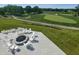 Relaxing outdoor space featuring a fire pit, Adirondack chairs, and scenic views of the lush golf course at 1230 Amberley Way, Westfield, IN 46074