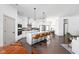 Bright, open kitchen with a large island, stainless steel appliances, and hardwood floors at 1230 Amberley Way, Westfield, IN 46074