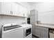 Functional laundry room with modern appliances, cabinets, and countertops for convenience at 1230 Amberley Way, Westfield, IN 46074