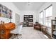 Bright home office with hardwood floors, built-in bookshelves, and ample natural light at 1230 Amberley Way, Westfield, IN 46074