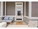 Welcoming front porch with comfortable seating and a stylish doormat at 1230 Amberley Way, Westfield, IN 46074