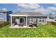 Charming backyard featuring a covered patio, outdoor seating, grilling area, and well-maintained lawn at 1239 Northcraft Ct, Franklin, IN 46131
