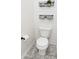 Cozy bathroom with a white toilet, functional storage baskets and stylish gray tile flooring at 1239 Northcraft Ct, Franklin, IN 46131