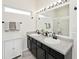 Modern bathroom with double sinks, sleek black faucets, and a well-lit mirror for convenience at 1239 Northcraft Ct, Franklin, IN 46131