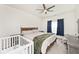 Bedroom with a bed, crib, and plenty of natural light from the window with blue curtains at 1239 Northcraft Ct, Franklin, IN 46131