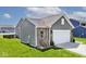 Back exterior showing garage, brick and siding detail, nice lawn with landscaping at 1239 Northcraft Ct, Franklin, IN 46131