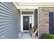 Front door with wreath accent, brick and siding detail, and welcome mat at 1239 Northcraft Ct, Franklin, IN 46131
