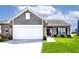 Charming home featuring a two-car garage, brick accents, neat lawn, and a welcoming entrance at 1239 Northcraft Ct, Franklin, IN 46131