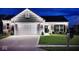 Inviting home exterior with manicured lawn, brick accents and tasteful lighting for enhanced curb appeal at 1239 Northcraft Ct, Franklin, IN 46131