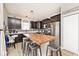 Spacious kitchen featuring dark cabinetry, stainless steel appliances, and a large kitchen island with seating at 1239 Northcraft Ct, Franklin, IN 46131