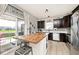 Modern kitchen features an island with seating, stainless steel appliances, and access to an outdoor patio at 1239 Northcraft Ct, Franklin, IN 46131