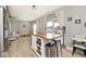 Open kitchen with island seating, stainless steel appliances, dark cabinets and view to living area at 1239 Northcraft Ct, Franklin, IN 46131