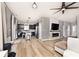 Open concept living area with wood floors, a fireplace, and a view of the kitchen and front entry at 1239 Northcraft Ct, Franklin, IN 46131