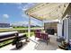 Relaxing covered patio with string lights, outdoor seating, and grill; ideal for outdoor entertainment at 1239 Northcraft Ct, Franklin, IN 46131