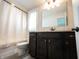 Well-lit bathroom with dark wood vanity, granite countertop, and a combination shower/tub for convenience at 12725 Parsons Gate, Carmel, IN 46032