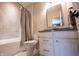 Modern bathroom with a combination tub and shower, a white vanity with grey countertop, and neutral wall colors at 12725 Parsons Gate, Carmel, IN 46032