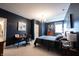 Stylish bedroom featuring dark blue walls, a comfortable bed, desk and artwork, creating a serene and inviting space at 12725 Parsons Gate, Carmel, IN 46032