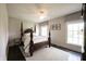 Spacious bedroom featuring a four-poster bed, hardwood floors, and bright natural light from two large windows at 12725 Parsons Gate, Carmel, IN 46032