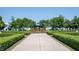 Scenic park view featuring a gazebo, colorful flowers, manicured hedges, and tree-lined walkway at 12725 Parsons Gate, Carmel, IN 46032