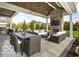 Spacious covered patio with outdoor seating, stone fireplace, ceiling fans, and built-in grill at 12725 Parsons Gate, Carmel, IN 46032