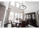 Bright dining area with a large table, elegant chandelier, and expansive windows at 12725 Parsons Gate, Carmel, IN 46032