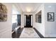 Elegant foyer showcasing a grand entryway, hardwood floors, chandelier, and decorative wall art at 12725 Parsons Gate, Carmel, IN 46032